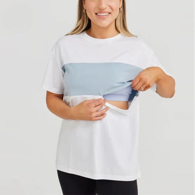 Colour-block nursing tee worn by a breastfeeding mum with discreet feeding access – Relievoo