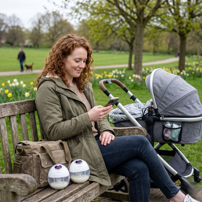 Mum pumping breast milk outdoors in park with pram - Relievoo portable wearable breast pump UK