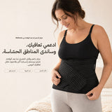 Woman wearing the black Relievoo postpartum support belt over a black vest top, holding the front support strap