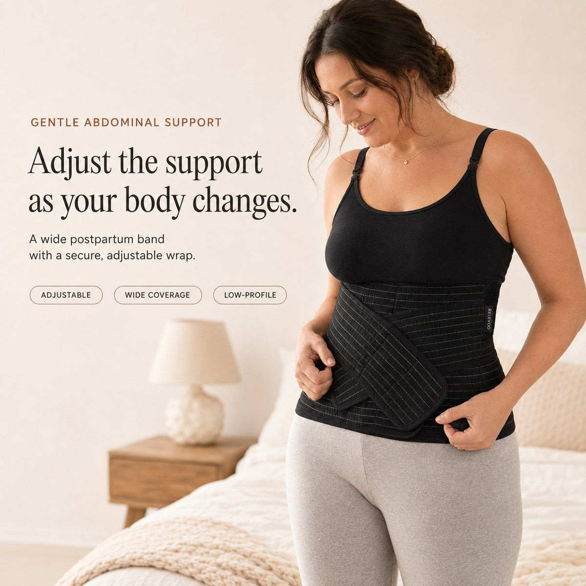 Woman wearing the black Relievoo postpartum belly band from the bundle, adjusting the front support strap rvpumpen rvhasar