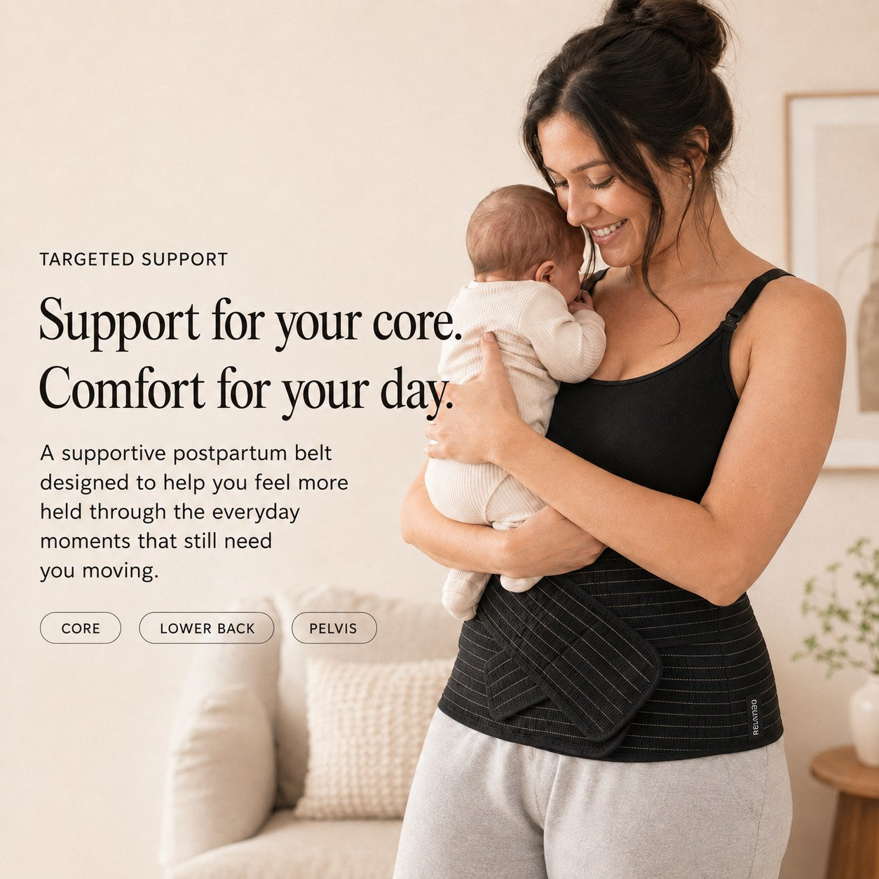 Mother holding her newborn while wearing the black Relievoo postpartum support belt