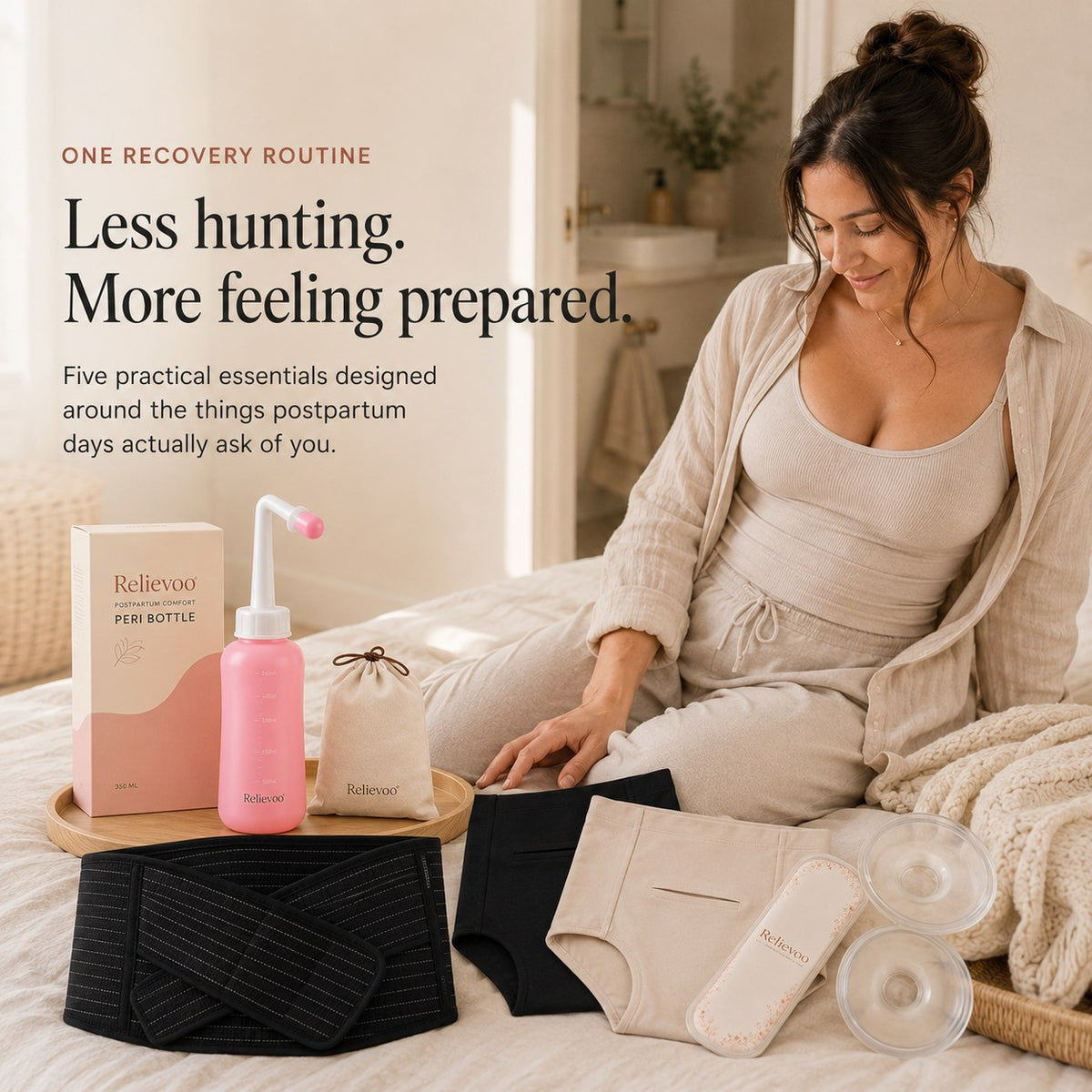 Woman sitting on a bed with the Relievoo postpartum recovery essentials bundle laid out beside her rvpumpen rvhasar