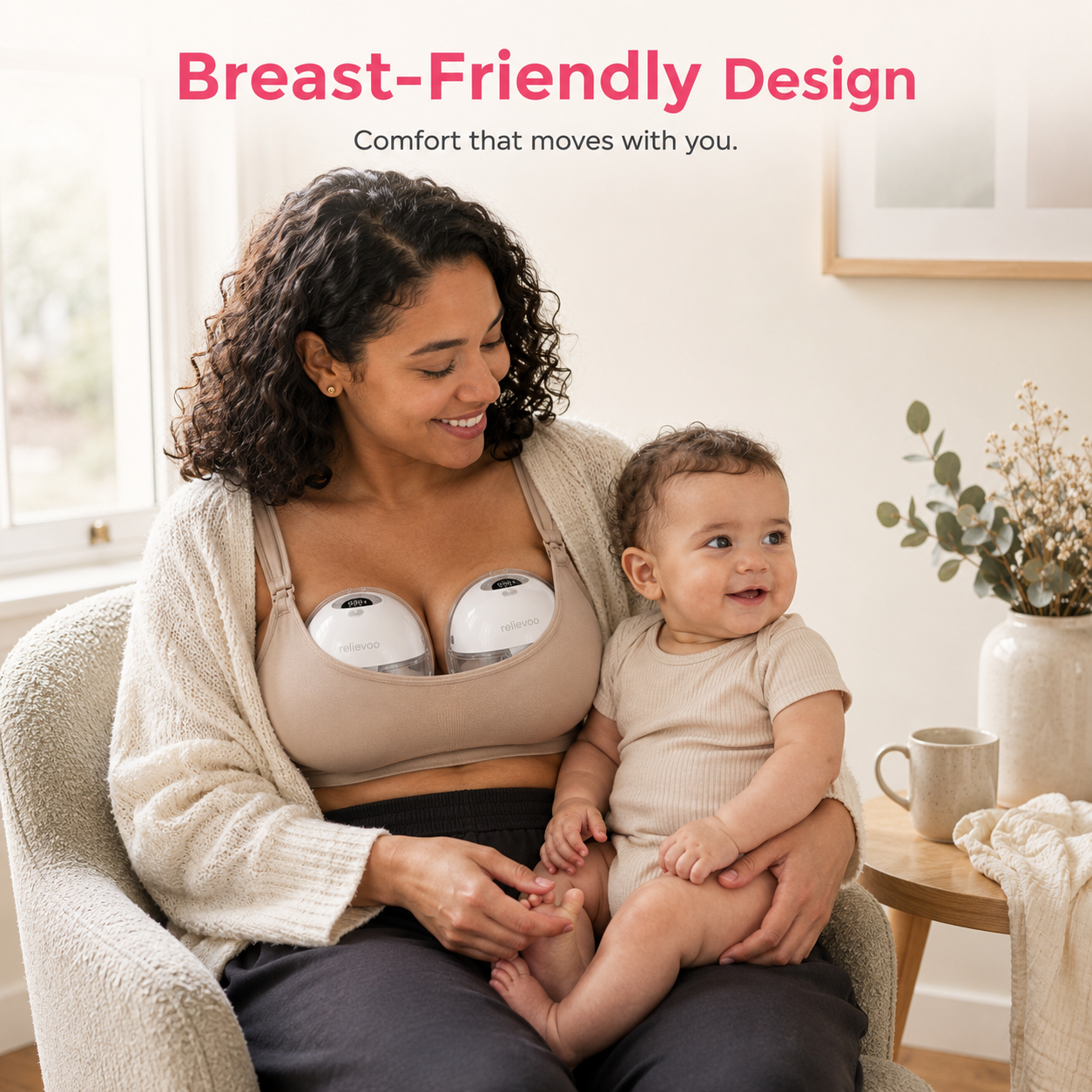 Mum wearing two Relievoo M22 PRO2 hands-free breast pumps inside her nursing bra while holding her baby at home, double wearable pumping with a breast-friendly design