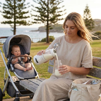 British mum using Relievoo Nomad portable bottle warmer at coastal park during golden hour
