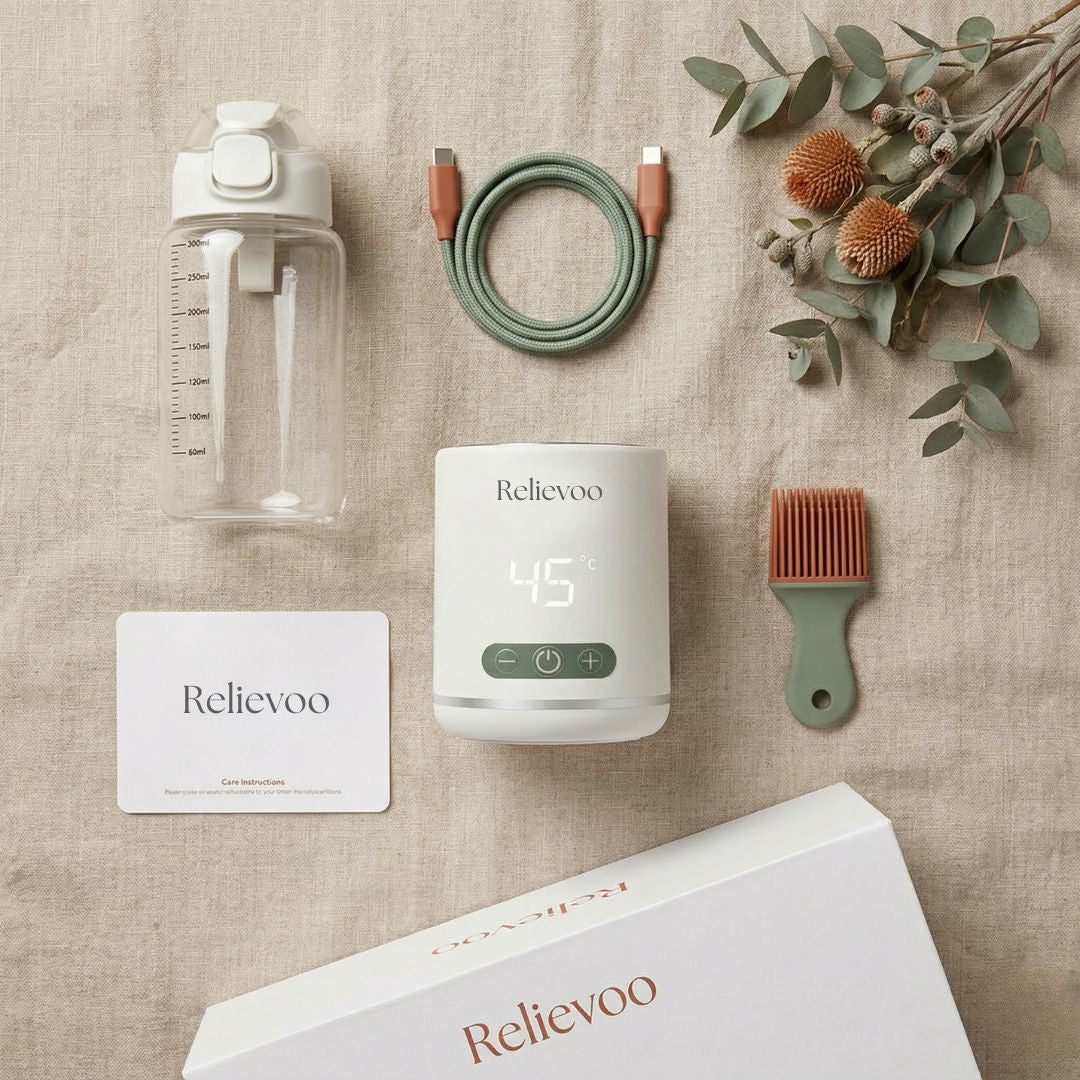 Relievoo Nomad Portable Bottle Warmer complete package flat lay - warmer base, glass bottle, USB-C cable, cleaning brush, care instructions card and retail box on linen