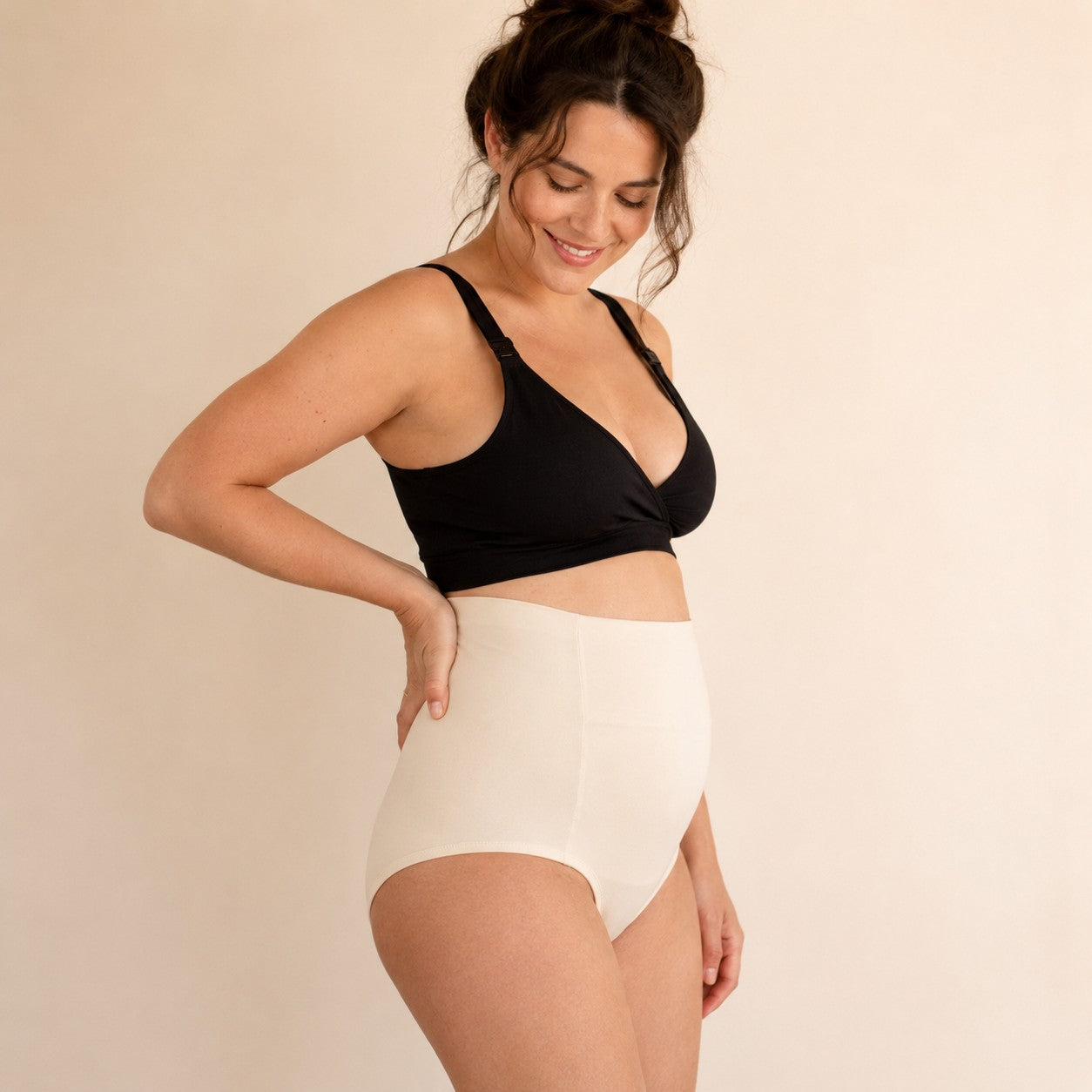 Side view of a mum wearing the ivory high-waisted postpartum soothing briefs
