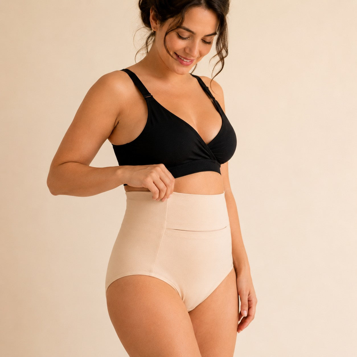 Mum adjusting the soft high waistband of the nude postpartum soothing briefs
