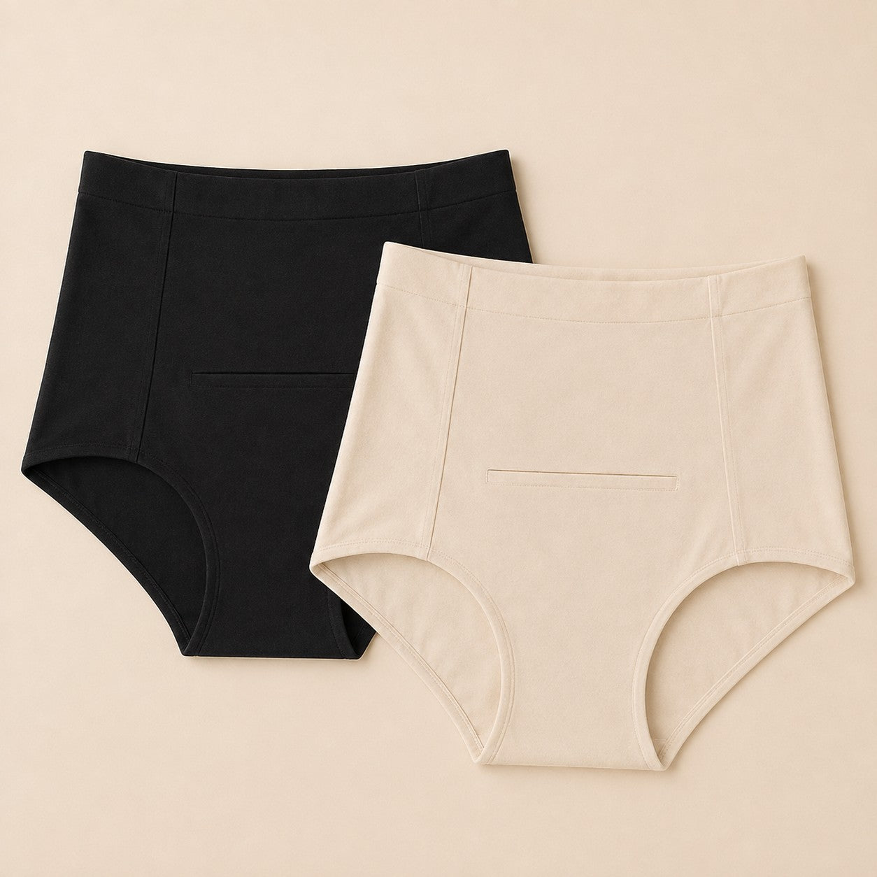 Relievoo Postpartum Soothing Briefs twin pack, one black and one ivory high-waisted brief laid flat