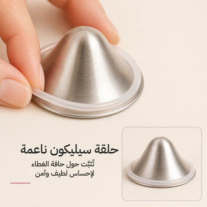 Fingers easing a soft clear silicone o-ring around the outer rim of a silver nursing cup