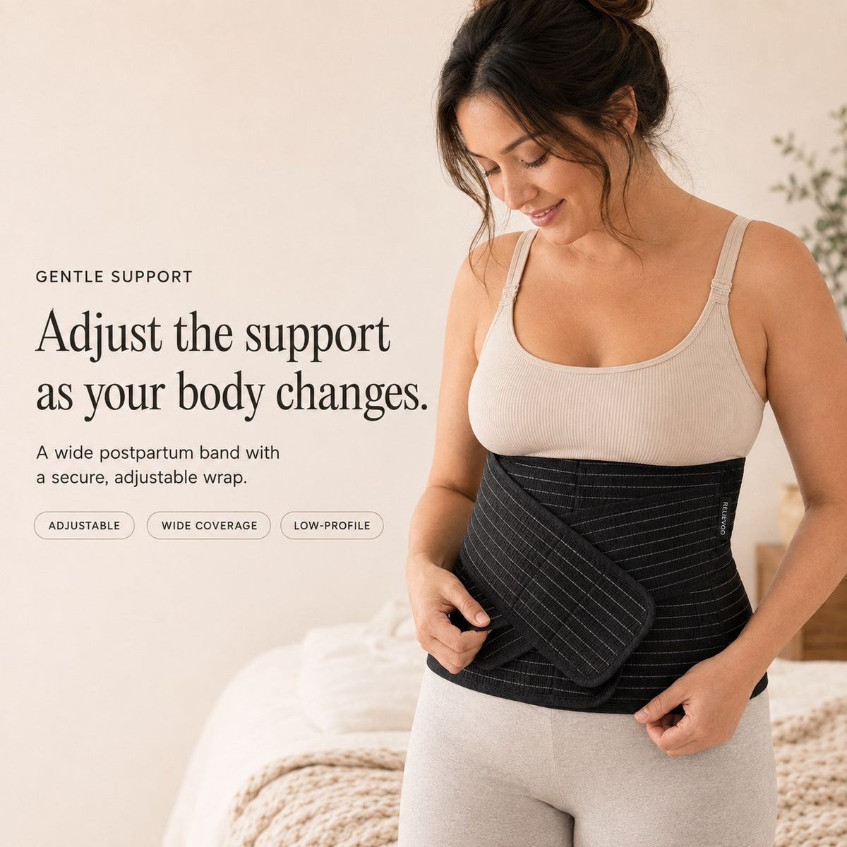 Woman adjusting the black Relievoo postpartum belly band from the complete recovery bundle rvpumpen