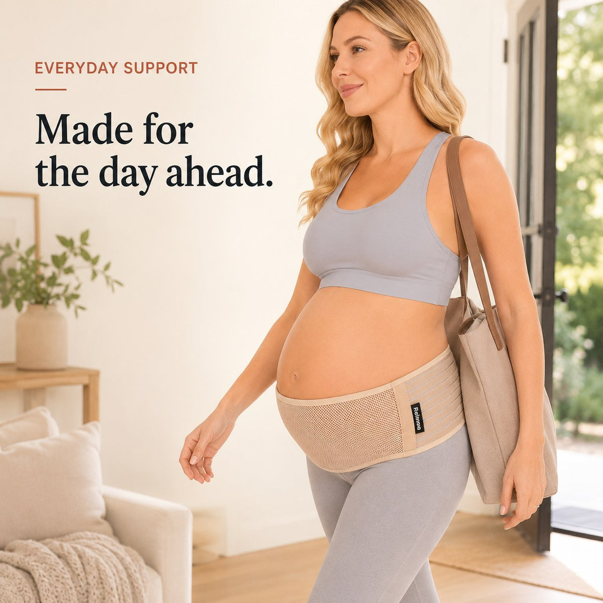 Pregnant woman walking out with a tote bag wearing the tan Relievoo pregnancy support belt rvpumpen