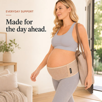 Pregnant woman walking out with a tote bag wearing the tan Relievoo pregnancy support belt rvpumpen