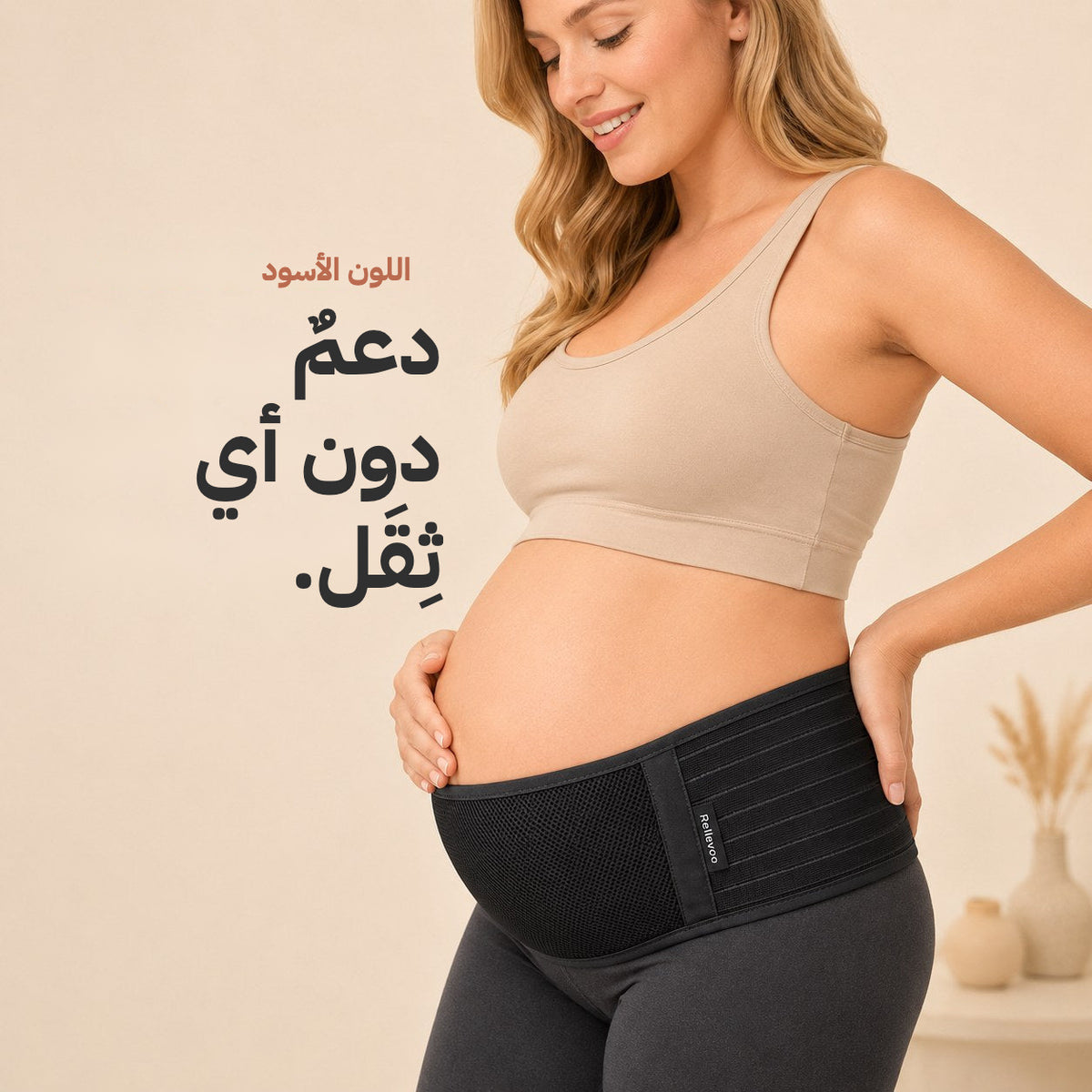 Pregnant woman wearing the black Relievoo pregnancy support belt under her bump