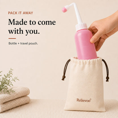 Relievoo peri bottle being placed into its cotton drawstring travel pouch beside folded towels
