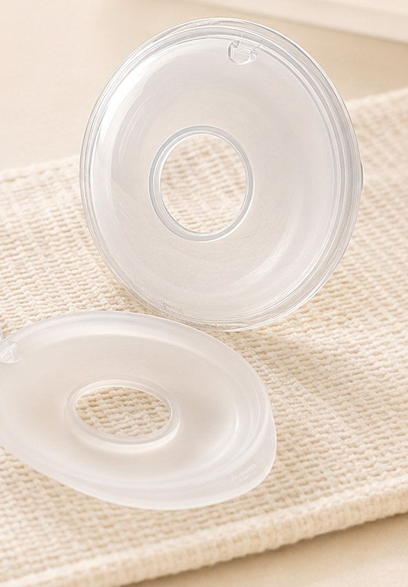 Close-up of a Relievoo collector separated into its soft silicone cushion and clear collection shell