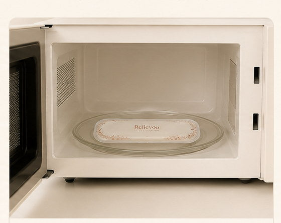 Relievoo therapy pack warming on a plate inside a microwave