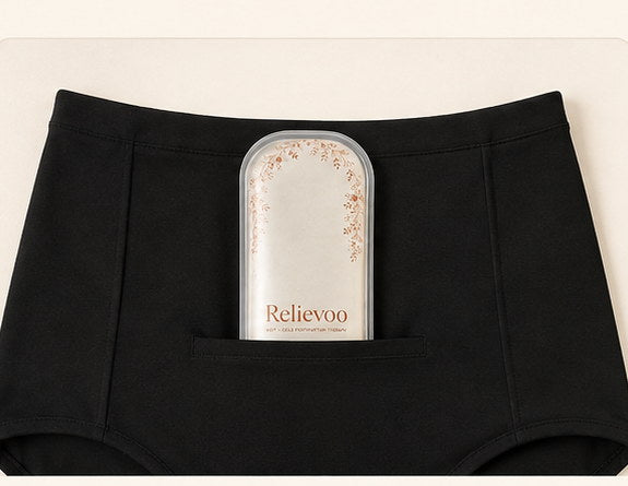 Relievoo therapy pack tucked into the front pocket of black postpartum briefs